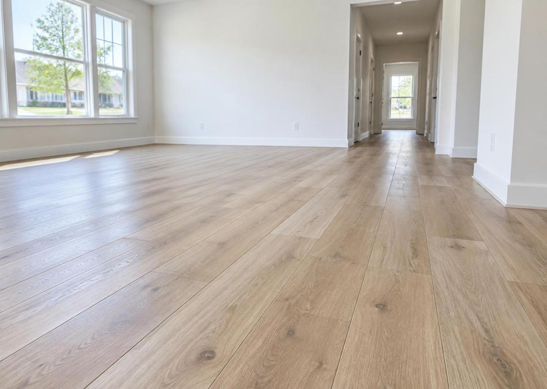 Newly installed luxury vinyl plank (LVP) flooring with clean baseboards